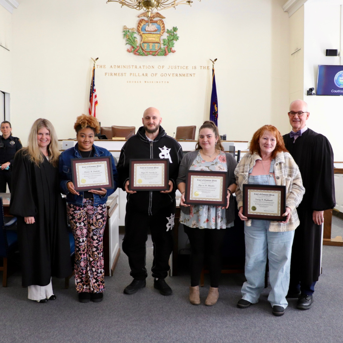 Photo of Judge Brewbaker and Judge Masland with the four graduates